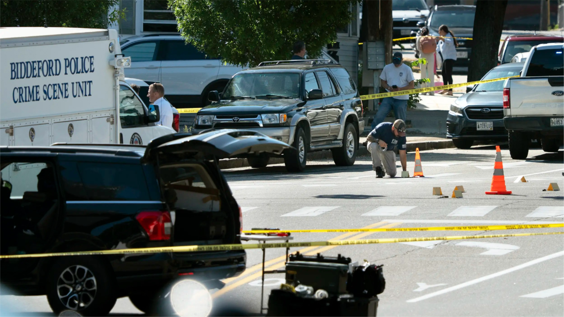 An FBI official places an evidence card on Pool Street in Biddeford where a man was reportedly killed in a shooting involving U.S. Immigration and Customs Enforcement agents.