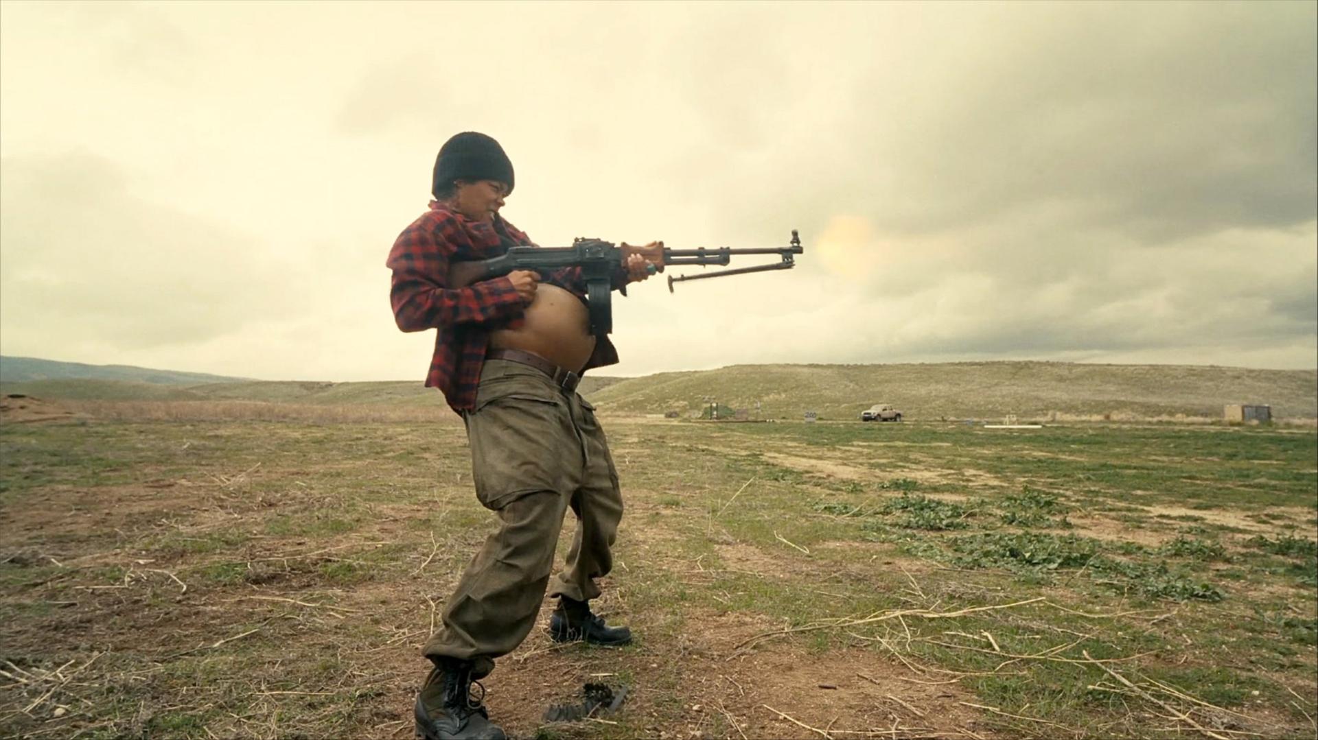 Teyana Taylor as Perfidia Beverly Hills firing a weapon while pregnant in the 2025 film One Battle After Another.
