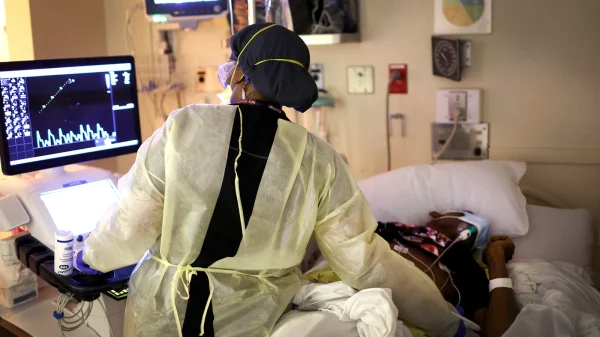 A medical professional performs an echocardiogram on a Covid-19 patient in the intensive care unit 