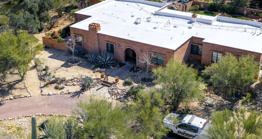 In an aerial view, a law enforcement vehicle is stationed outside of Nancy Guthrie's residence on February 11 in Tucson, Arizona. 