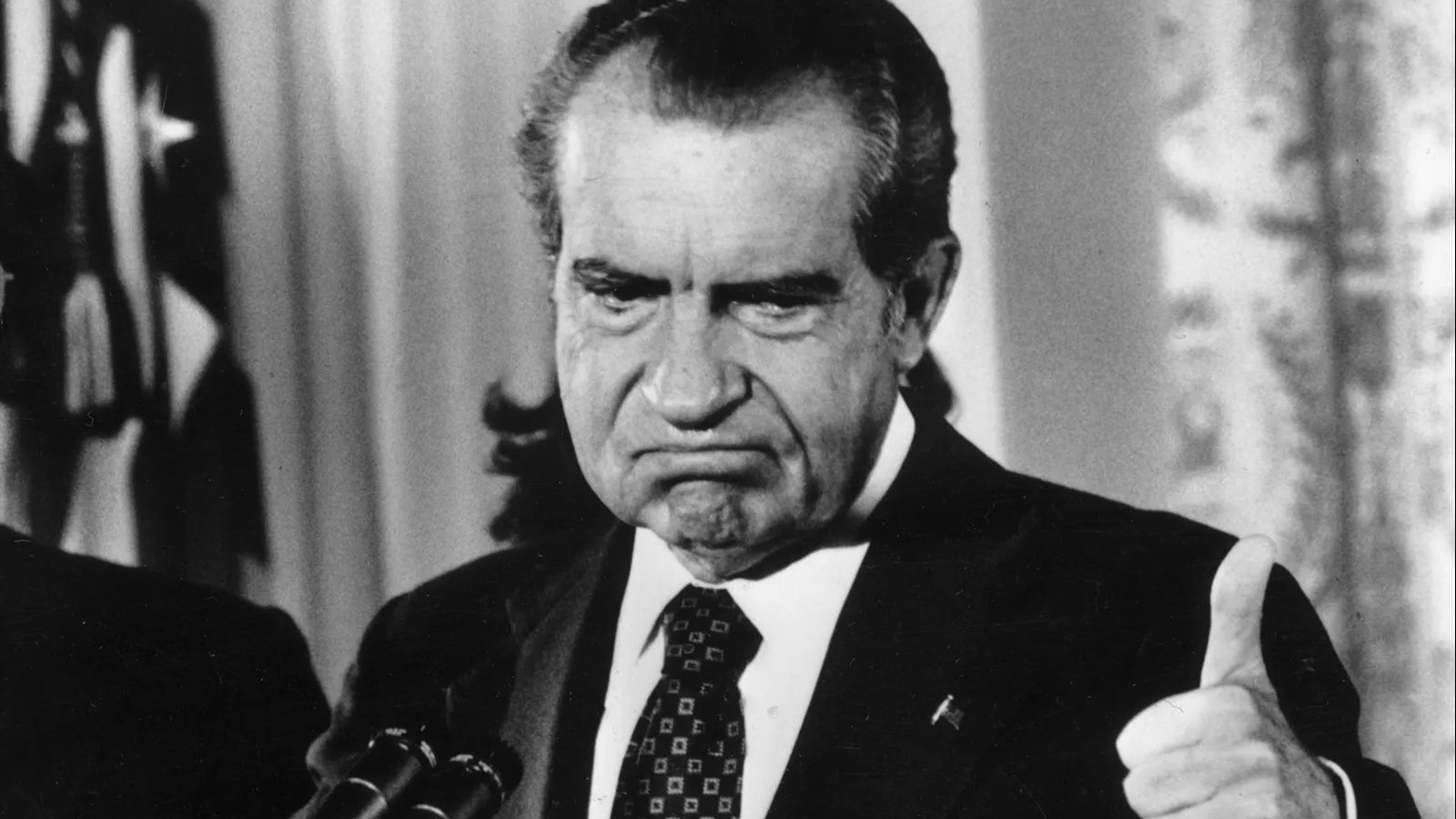 Richard Nixon looks upset as he resigns.