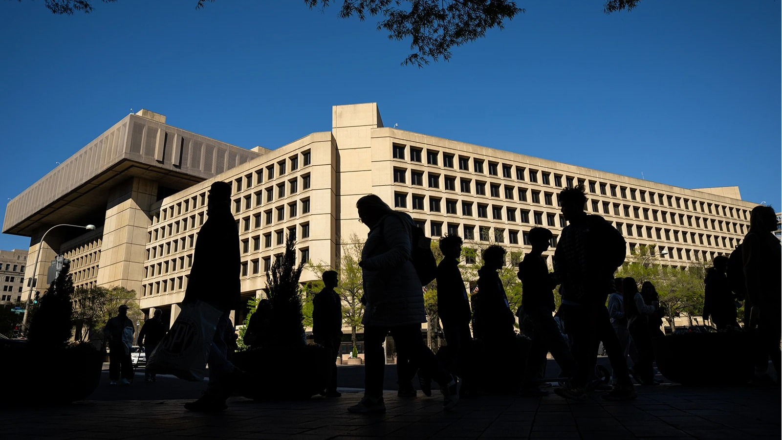 People walk by FBI headquarters.