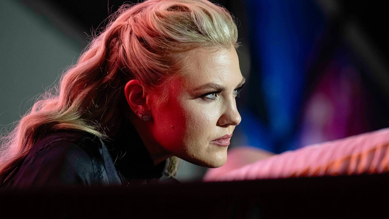 In this closeup photo, Erika Kirk is seen from her right side as she leans forward, listening intently.