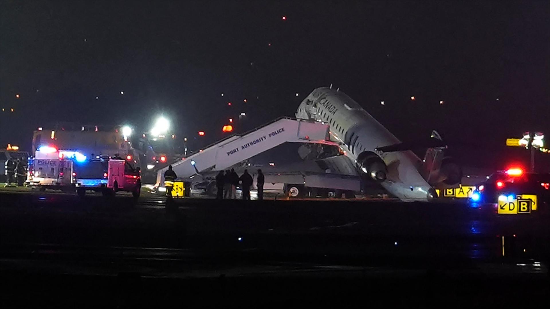 Air Canada Jet sits on the runway at LaGuardia Airport after colliding with a Port Authority vehicle in New York