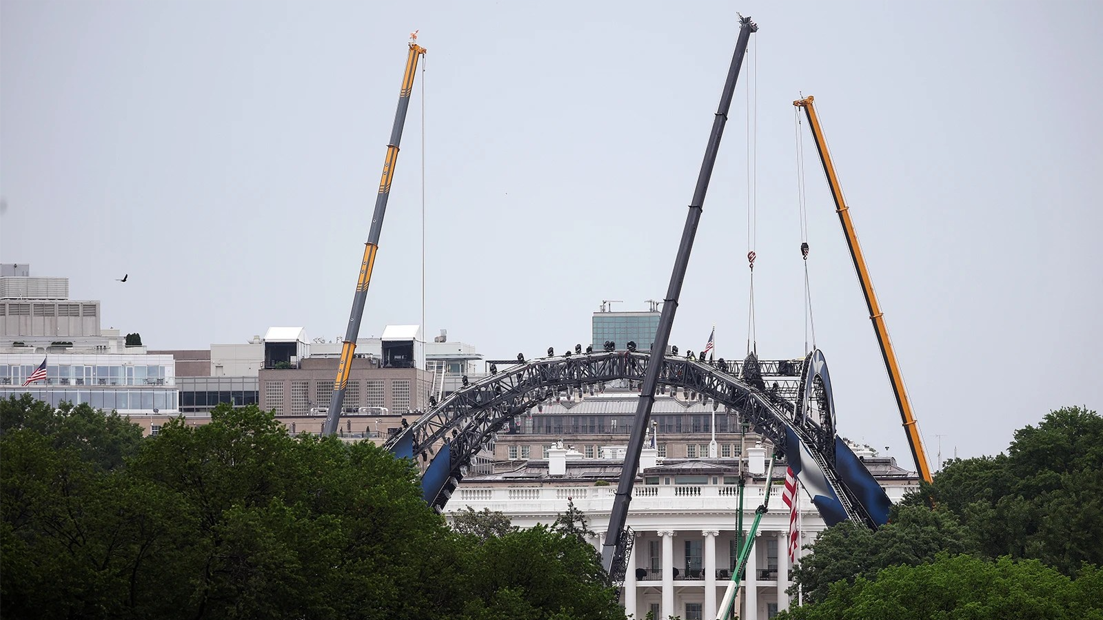 The White House and construction of UFC arena in front of it are seen behind trees.