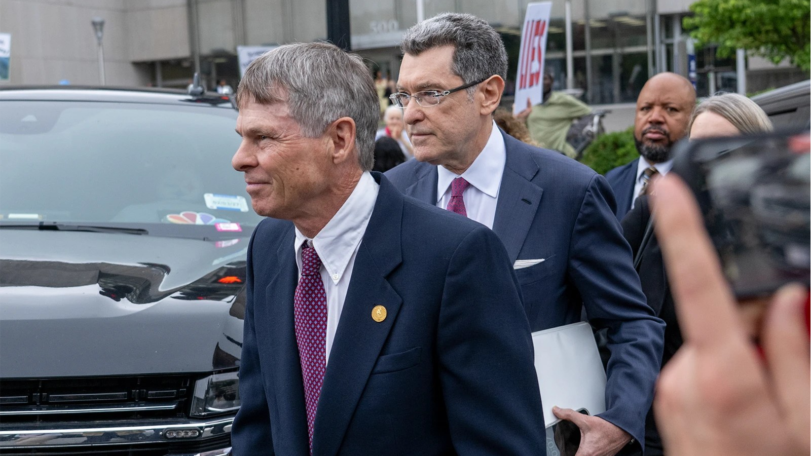 Former Olympian David Hearn, left, and attorney Norman Eisen, representing David Hearn, depart D.C. Superior Court in on  July 9, 2026.  