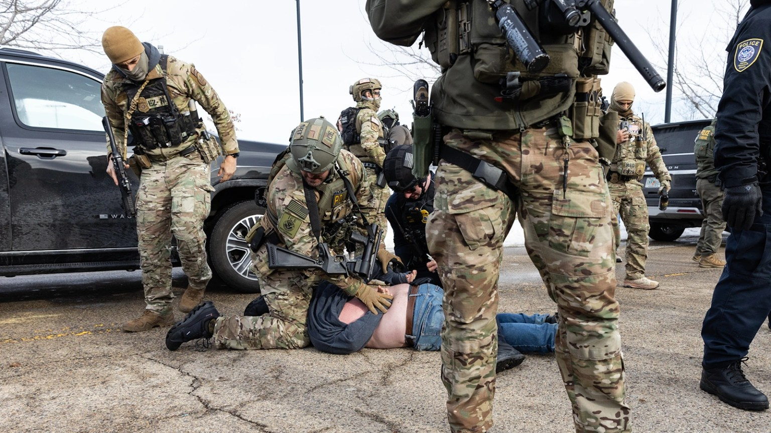 Federal agents arrest a protester outside an ICE facility 
