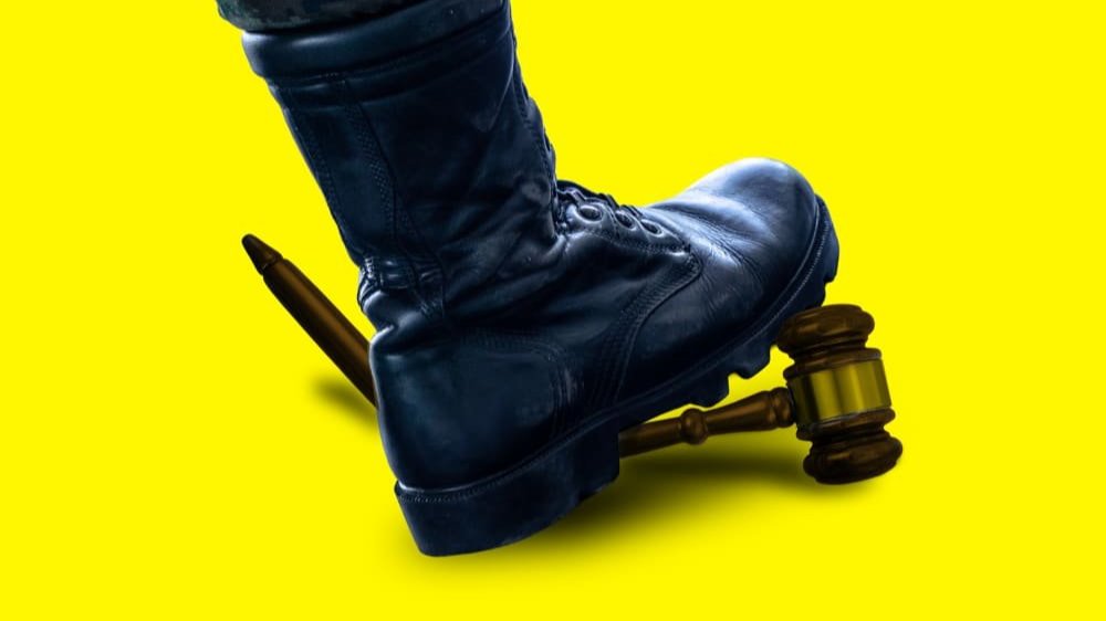 A boot stepping on a gavel