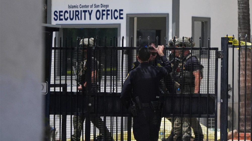 Armed officers stand outside the Islamic Center of San Diego after a shooting on May 18, 2026, in San Diego.