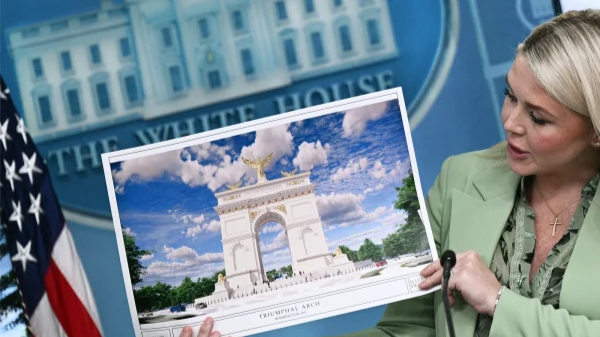 White House Press Secretary Karoline Leavitt shows an artist's rendering of President Donald Trump's planned Triumphal Arch during a press briefing in the Brady Briefing Room at the White House.