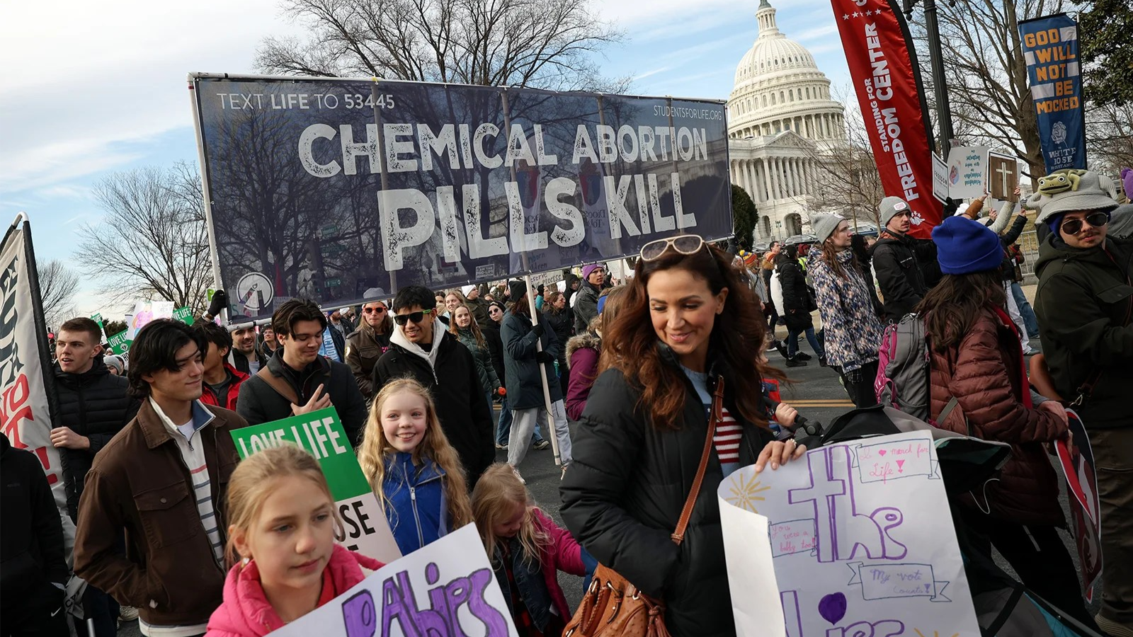 Protesters hold anti-abortion signs