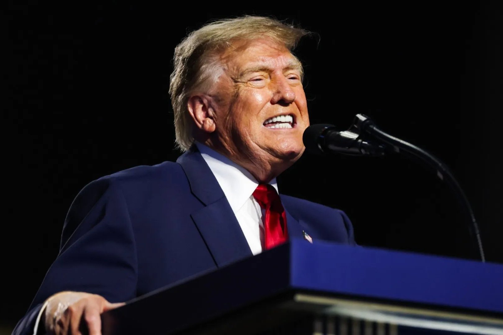 Donald Trump speaks from behind a podium