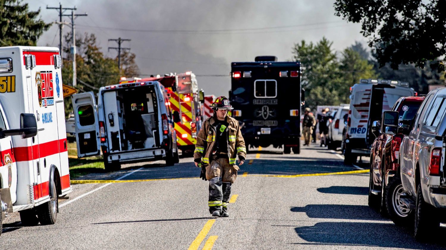 A firefighter walks down the street where emergency services are responding to a shooting and fire at the Church of Jesus Christ of Latter-day Saints on Sept. 28, 2025, in Grand Blanc, Mich.