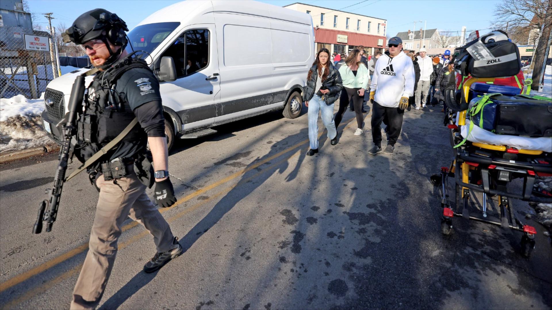 Protesters and activists sit in front of an ICE facility