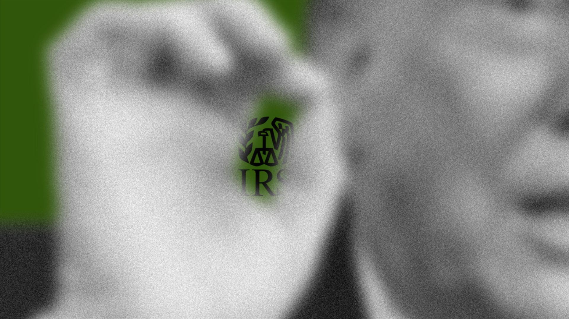 Photo of IRS logo behind Trump's fingers