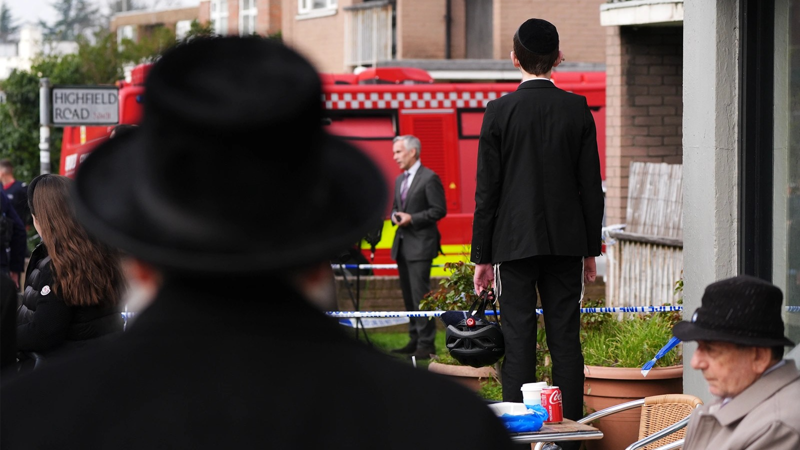 Jewish community members watch a fire truck