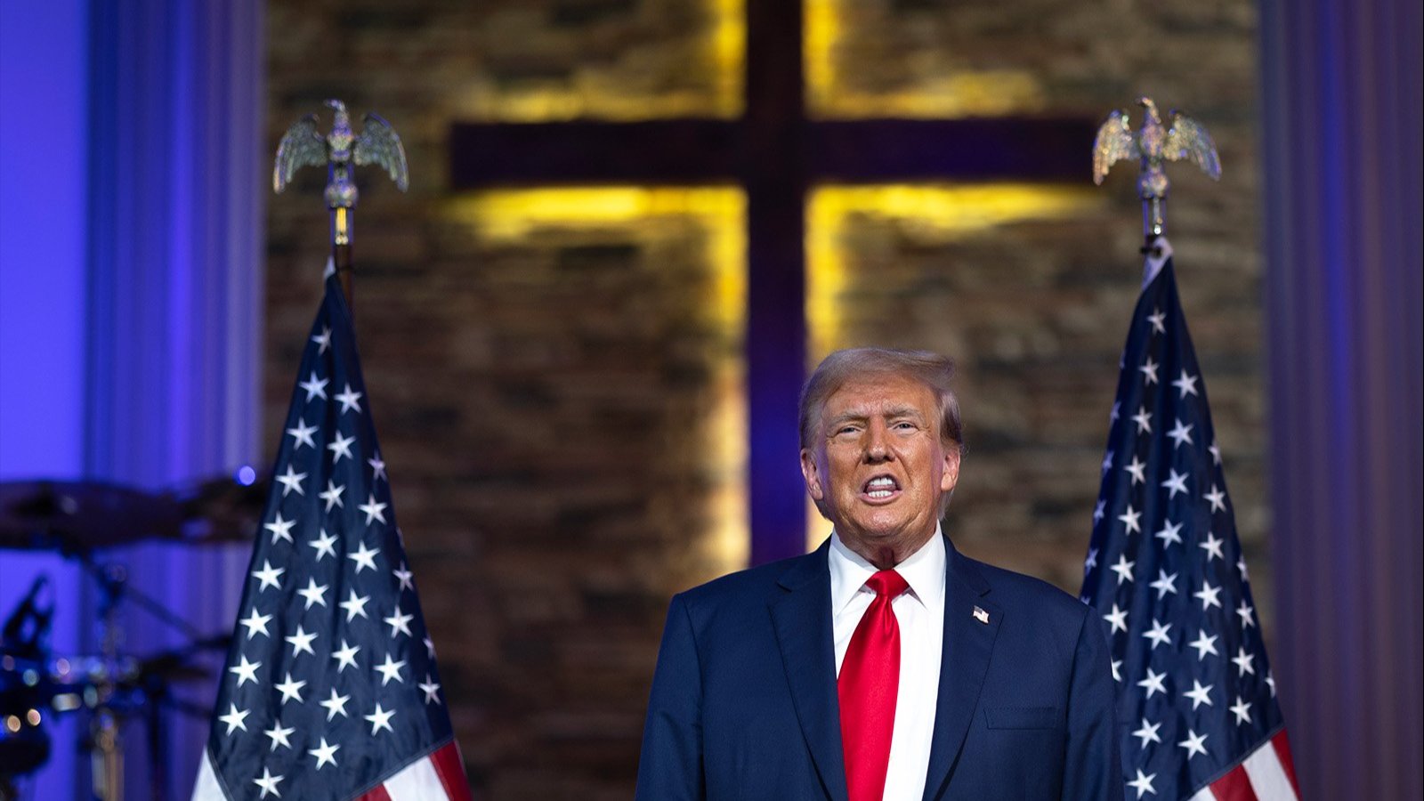 A photo of Trump in front of a cross