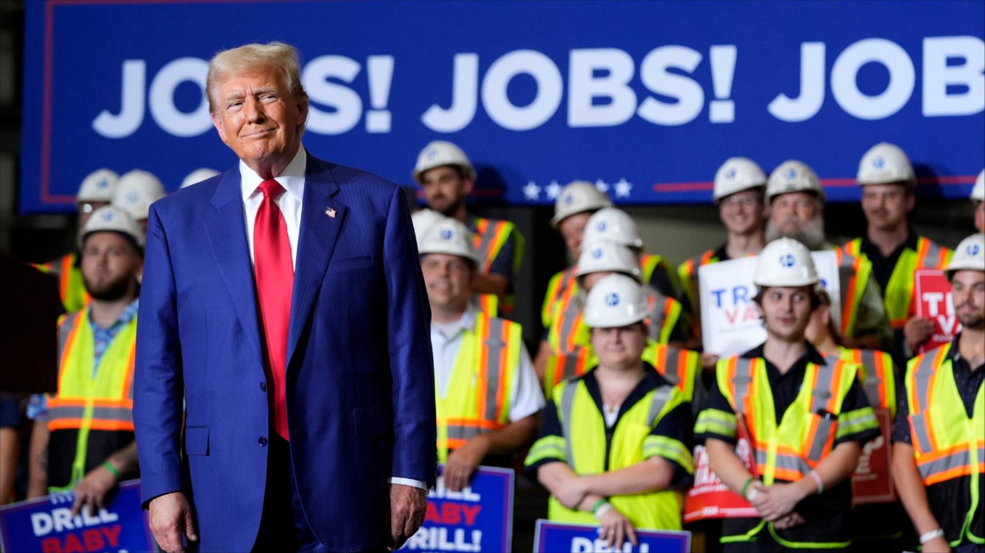 President Donald Trump in front of people dressed in yellow vests
