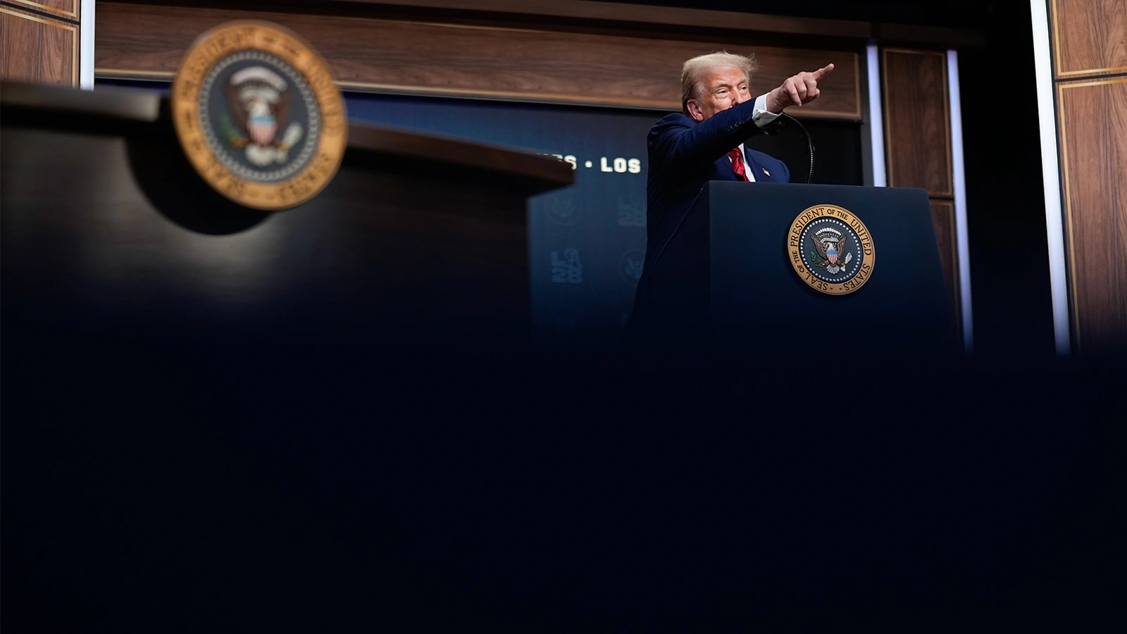 A photo of Trump pointing from a podium