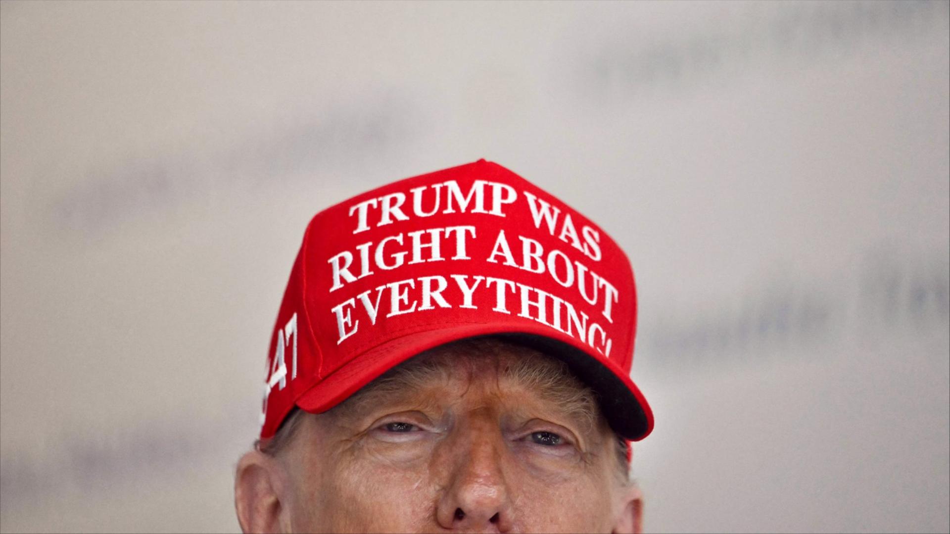 President Donald Trump wears a hat that reads 