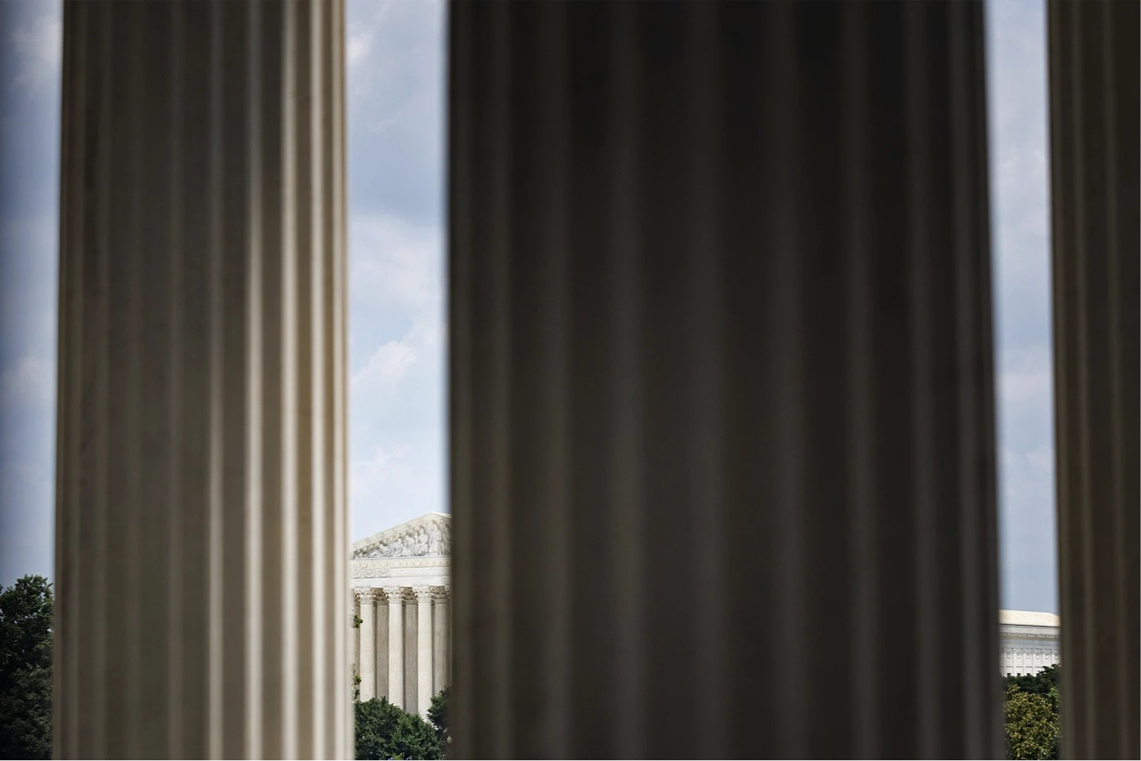 The Supreme Court is partially visible behind columns in the foreground.