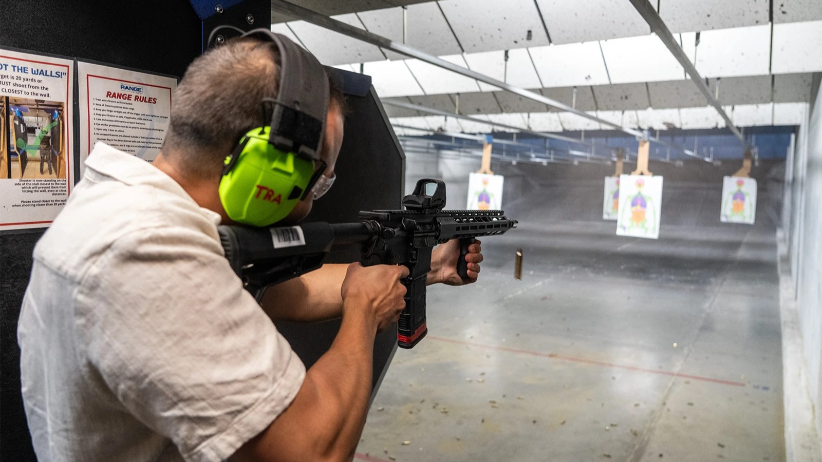  A man shoots an AR-15 rifle.