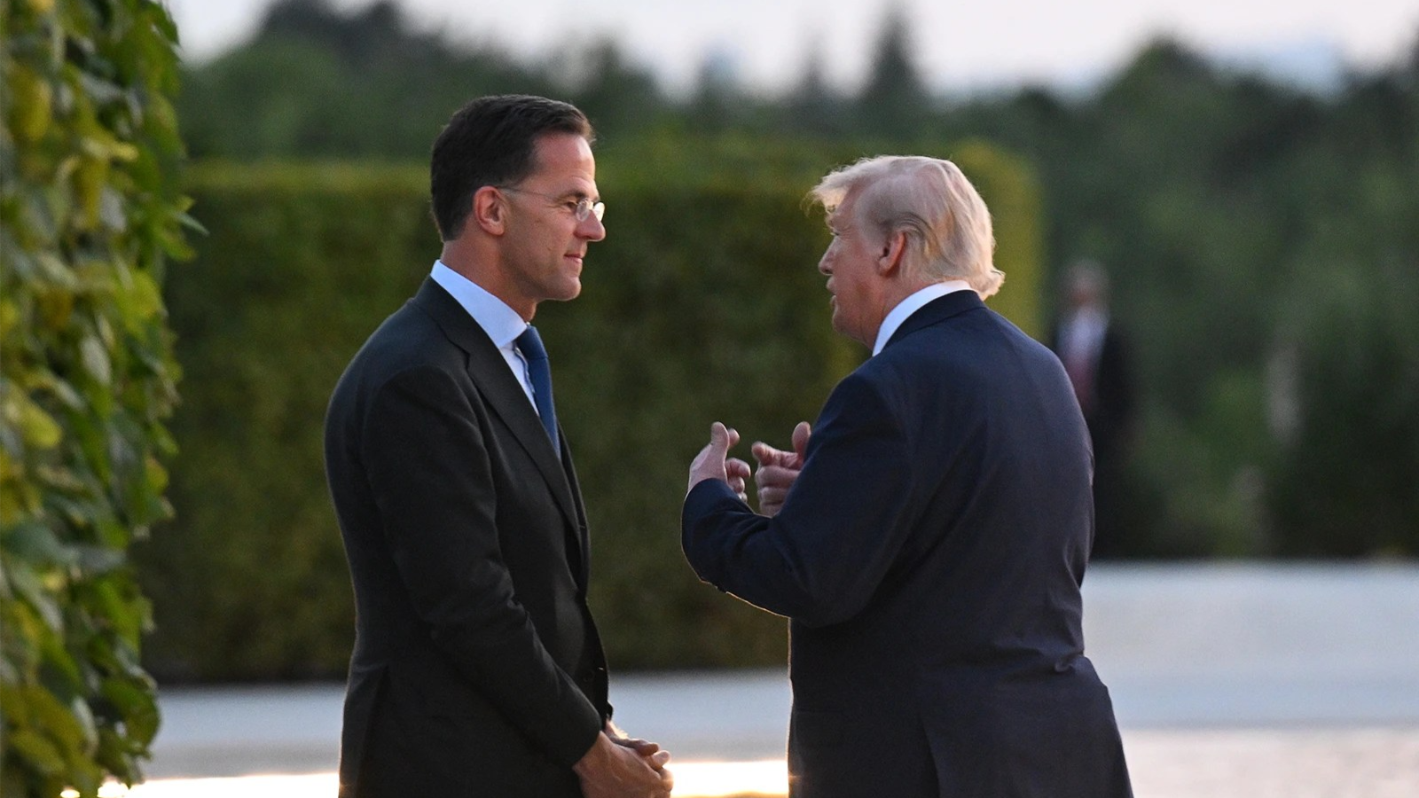 Mark Rutte, left, and Donald Trump speak outside.