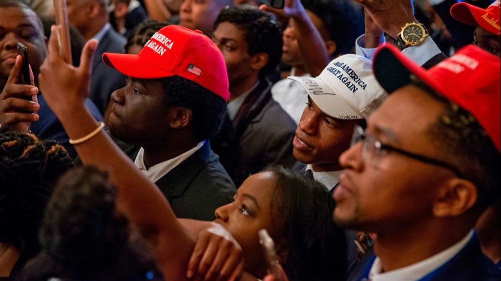 White House guests listen as President Donald Trump addresses the Young Black Leadership Summit at the White House on Oct. 26, 2018.