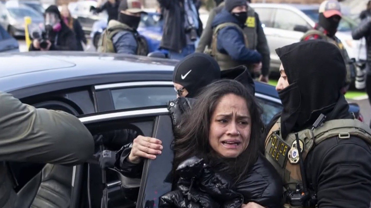 ICE agents holding person