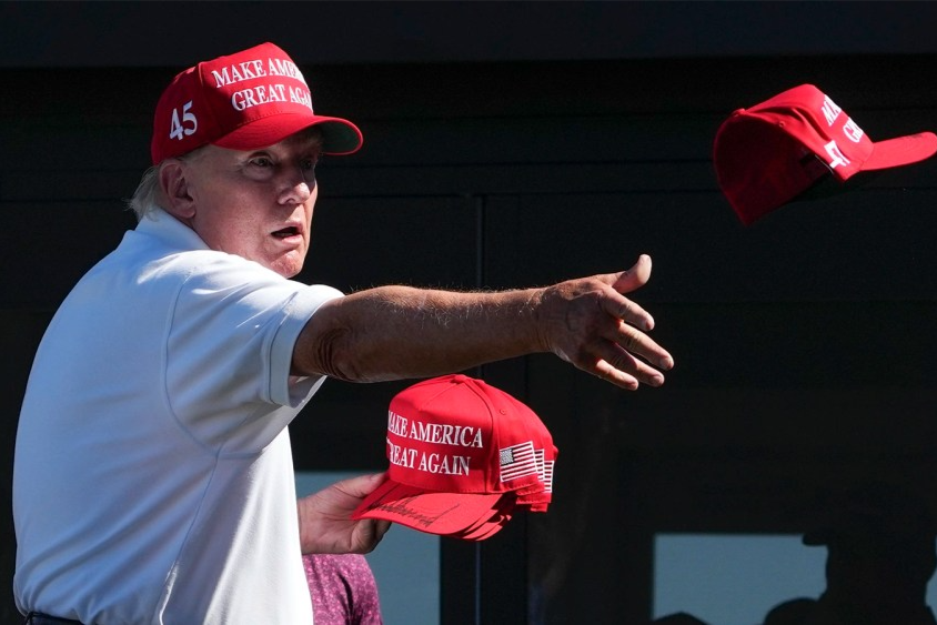 Donald Trump throws autographed hats to the crowd during the final round of the Bedminster Invitational LIV Golf tournament on Aug. 13, 2023, in Bedminster, N.J.