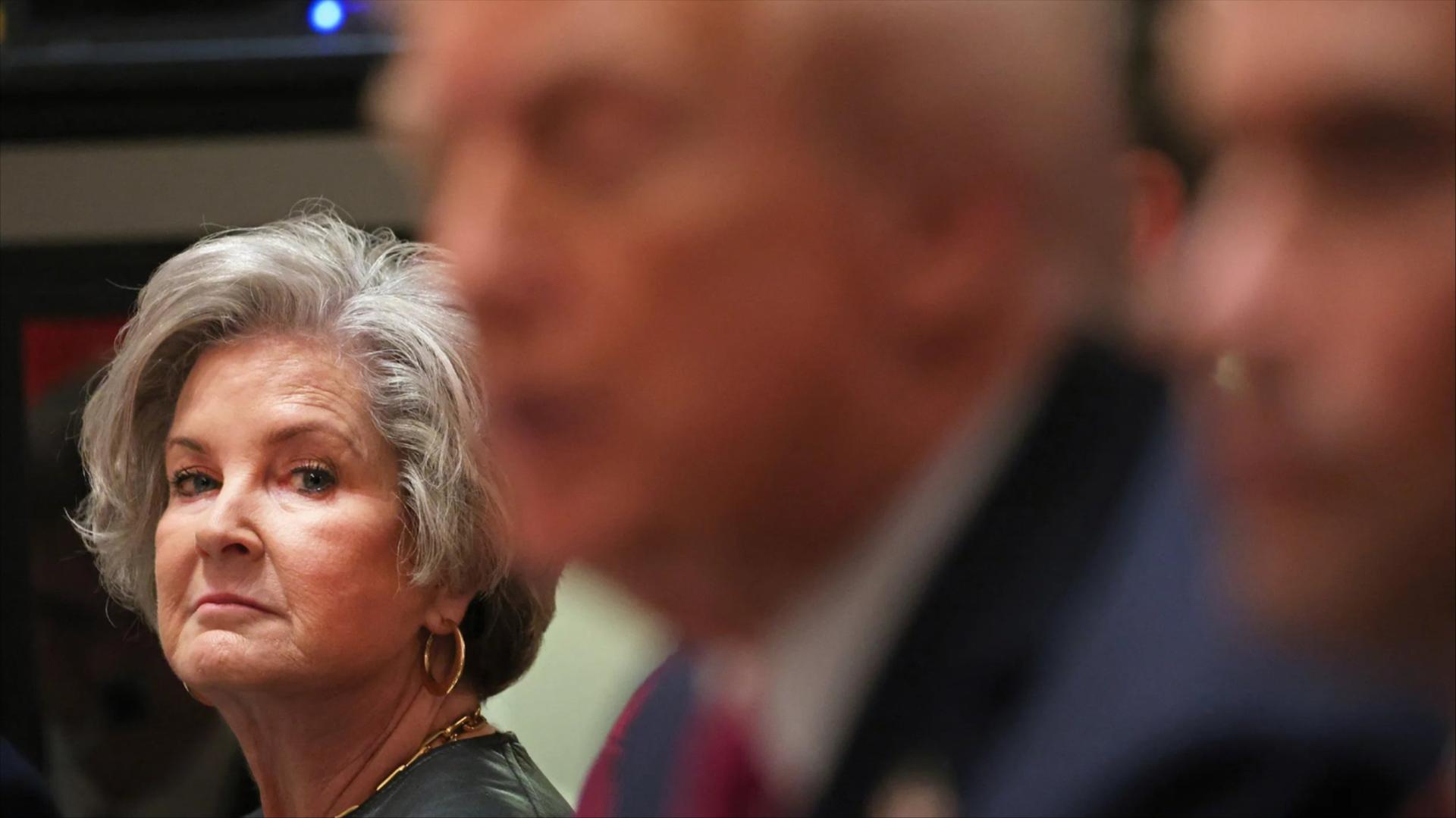 Susie Wiles, left and in focus, looks at Donald Trump, right and out of focus.