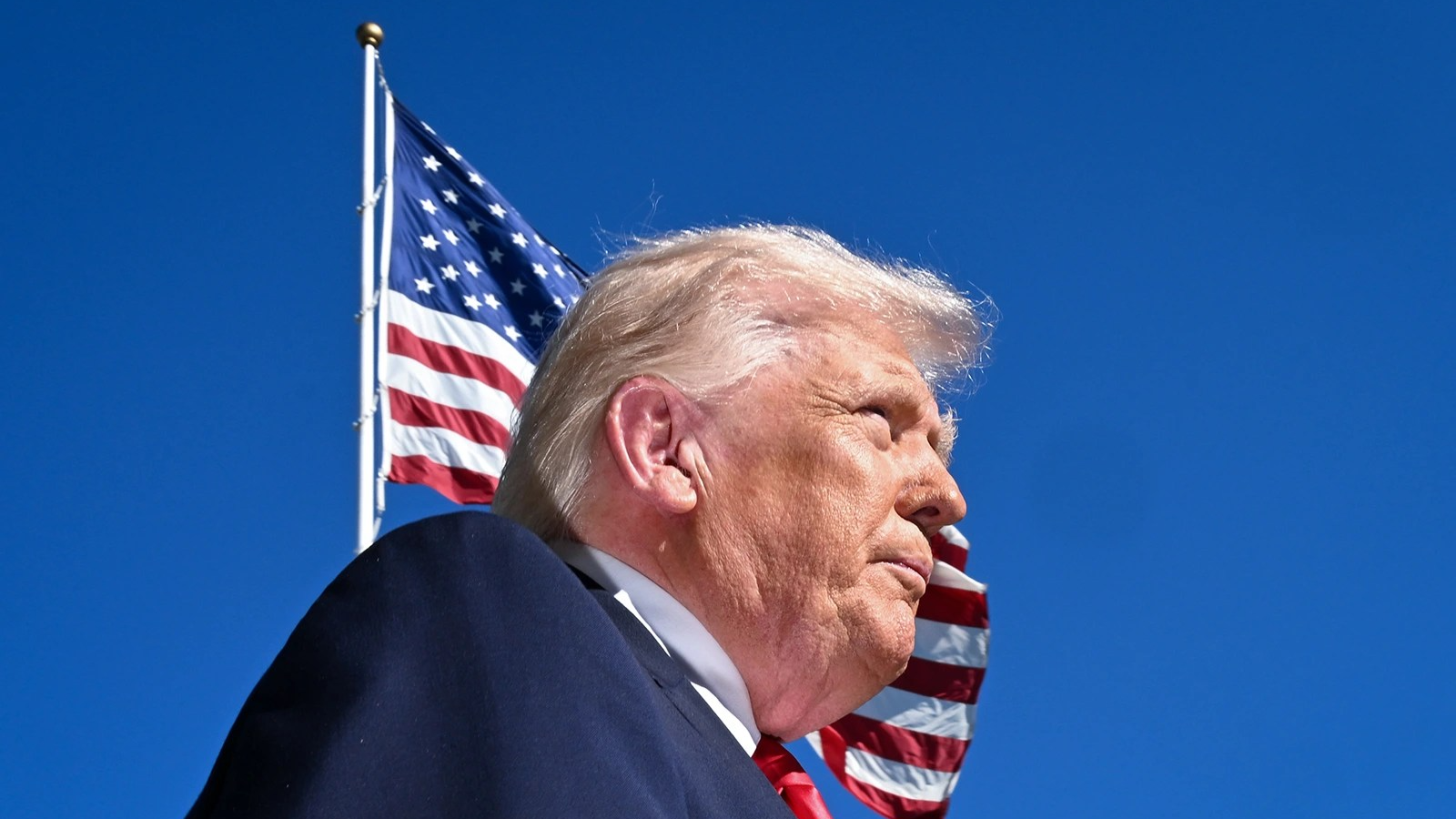 A photo of Trump with an American flag behind him