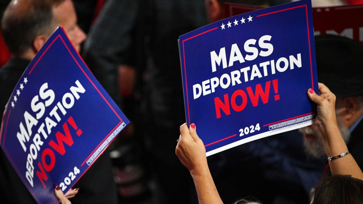 People holding signs saying 