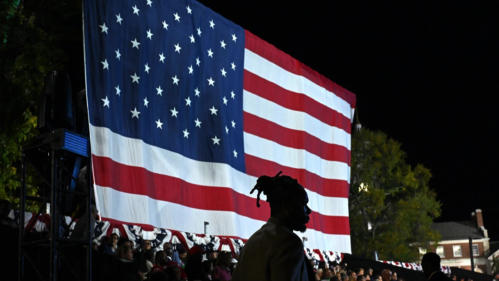 Person stands in front of American flag