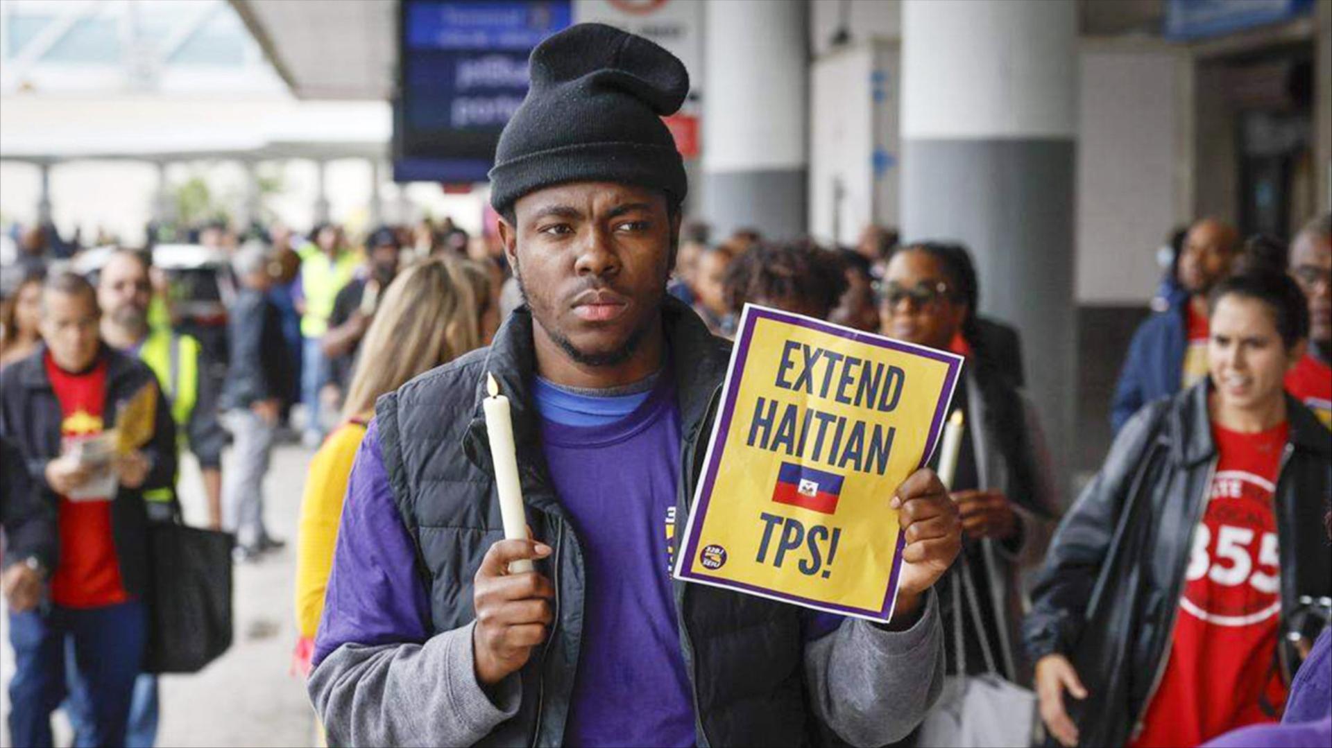 Protesters during a candlelight vigil calling on the Trump administration to extend TPS for Haitian immigrants