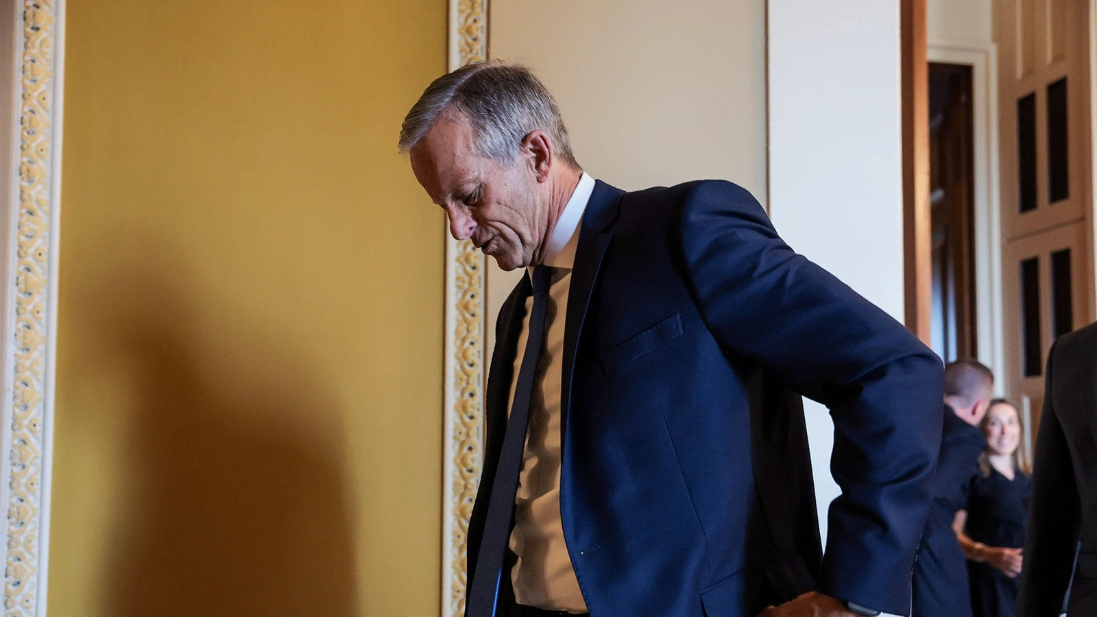John Thune, seen at profile, with his head tilted down.