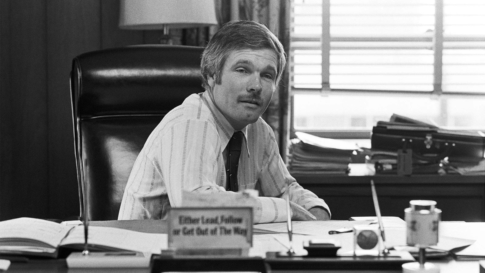 Ted Turner sits at his desk in 1977