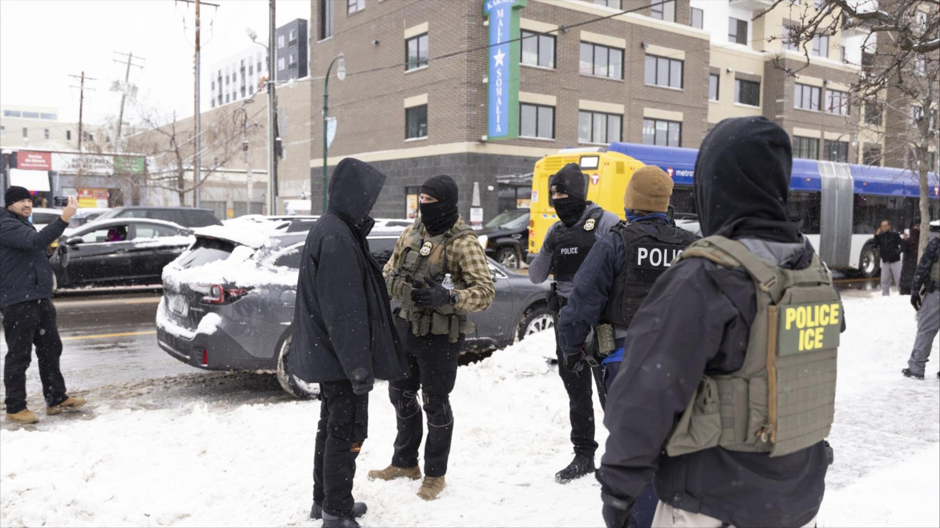 ICE officers question a man in Minnesota