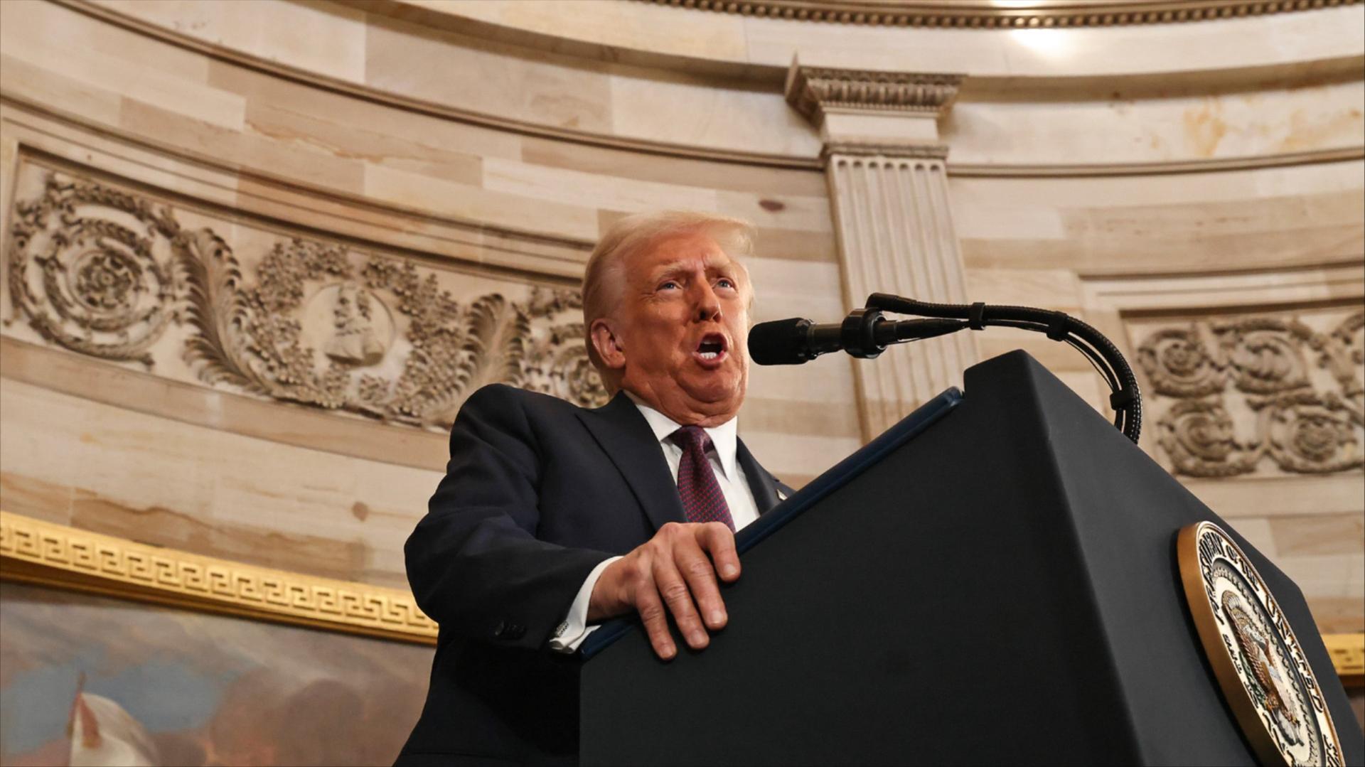 President Trump speaks into a microphone at a podium