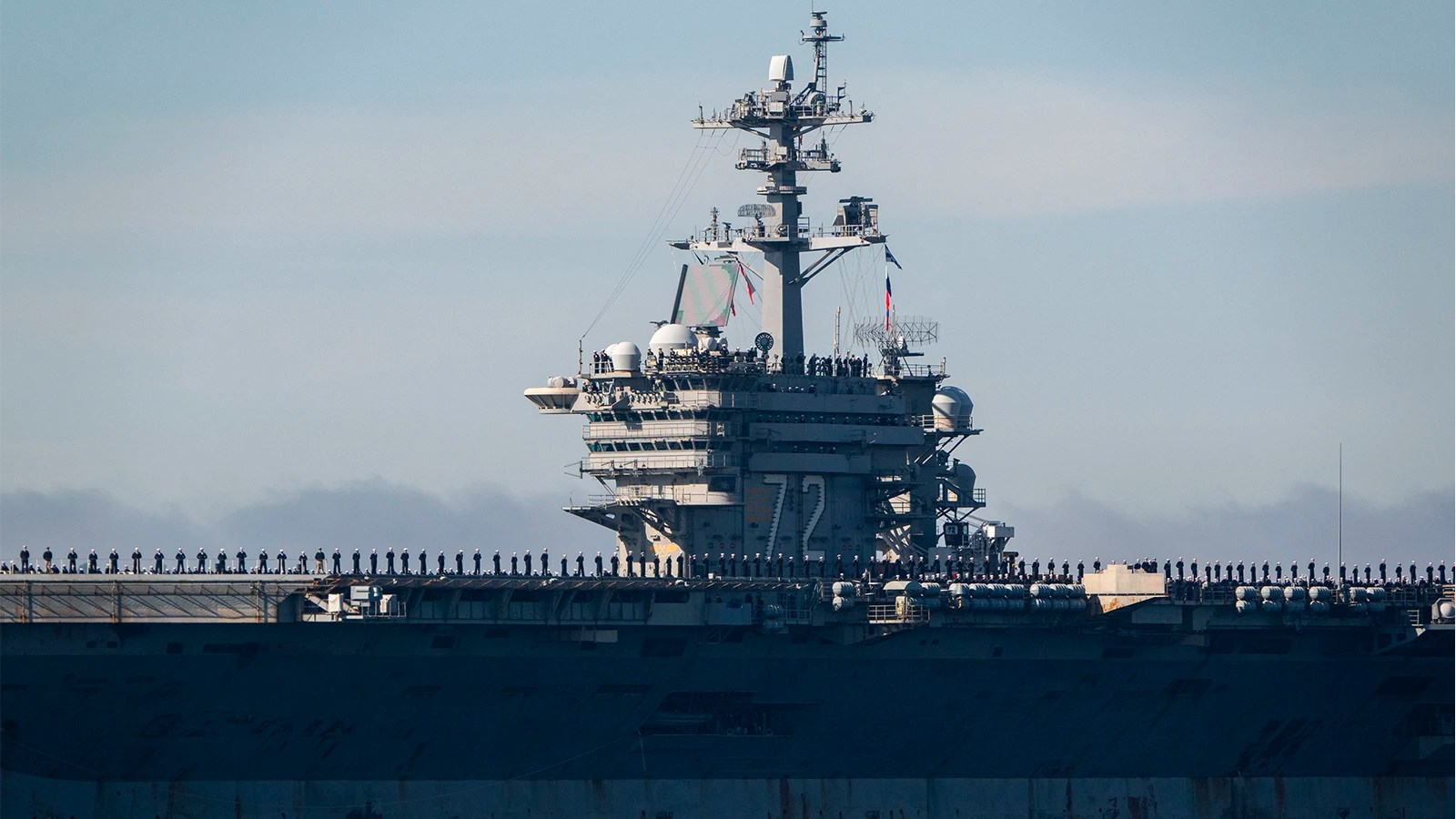 Sailors man the rails as the USS Abraham Lincoln returns to its homeport on Dec. 20, 2024, in San Diego.