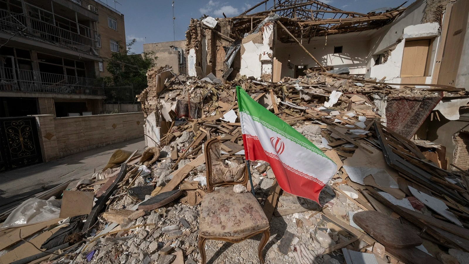An Iranian national flag on the ruins of a building on May 14, 2026, in Tehran, Iran