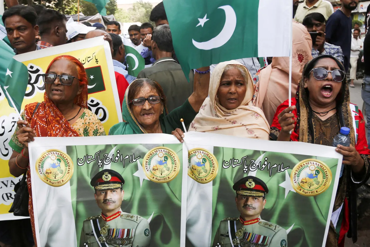 Members of the Pakistani Hindu community hold flags and placards showing the picture of Chief of Army Staff of Pakistan Asim Munir, as they chant slogans during a rally in support of the Pakistan Army, in Karachi, Pakistan May 10, 2025. 