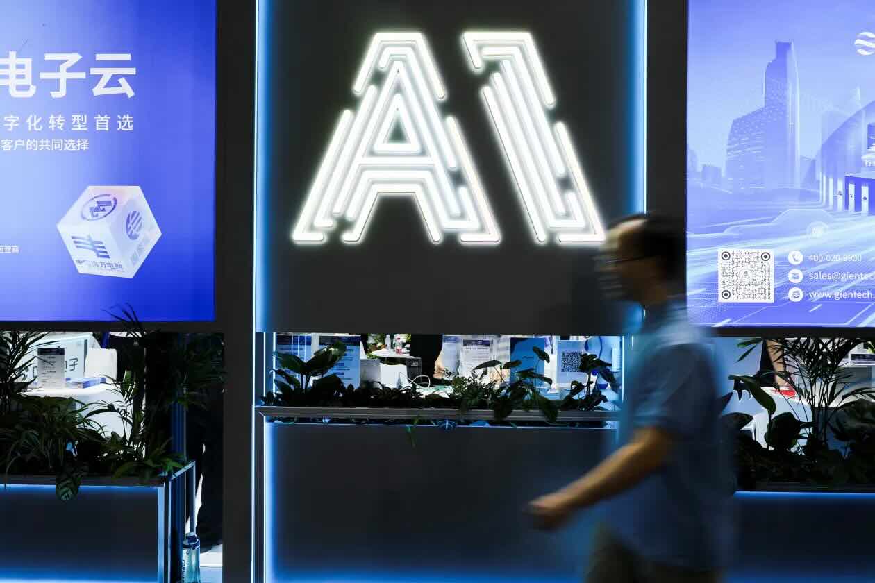 Image of a billboard with a neon 'AI' on it from the World Artificial Intelligence Conference, Shanghai, July 2025