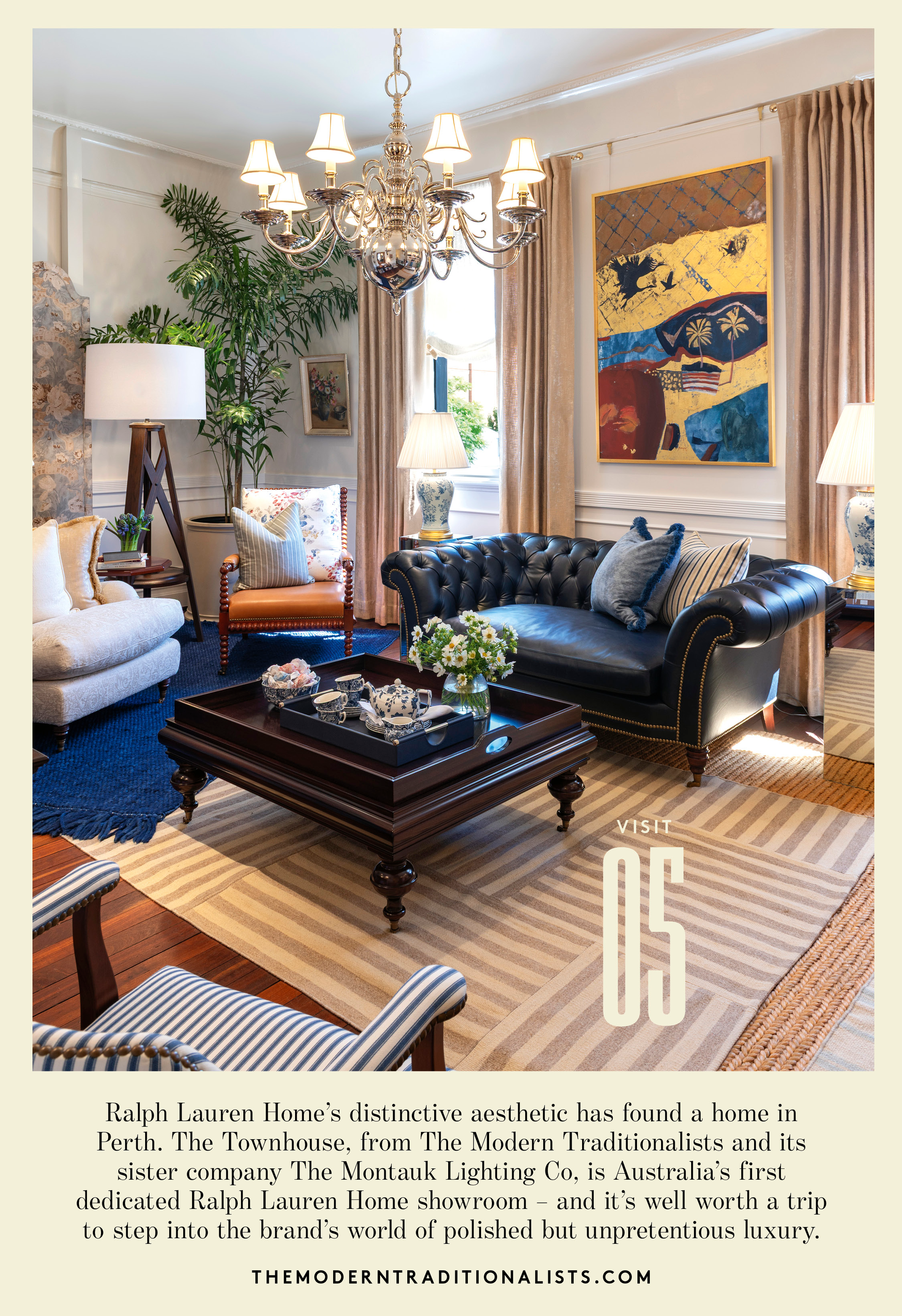 A room with a blue leather chesterfield sofa, timber cofee table with turned legs, cahndleier and standing lamps