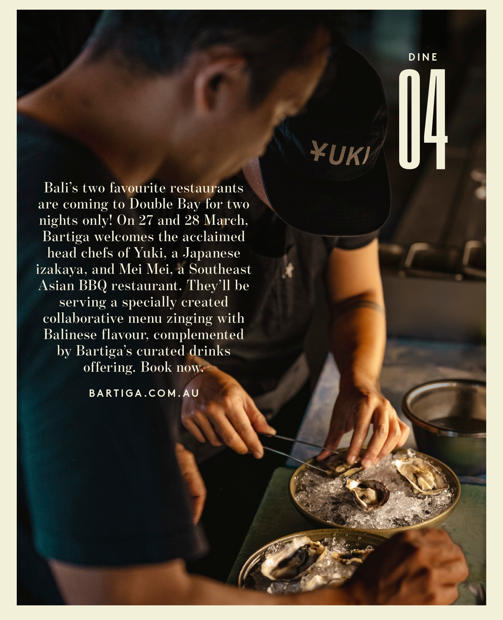 Two chefs in black lean over a dish filled with ice and topped with oysters