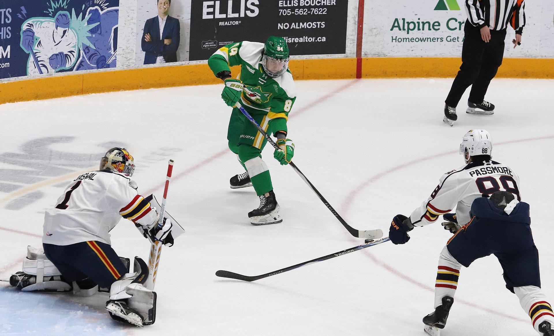 Artem Gonchar, middle, of the Sudbury Wolves, looks for an angle to shoot as goalie Arvin Jaswal and Evan Passmore, of the Barrie Colts, follow the play during OHL action at the Sudbury Community Arena in Sudbury