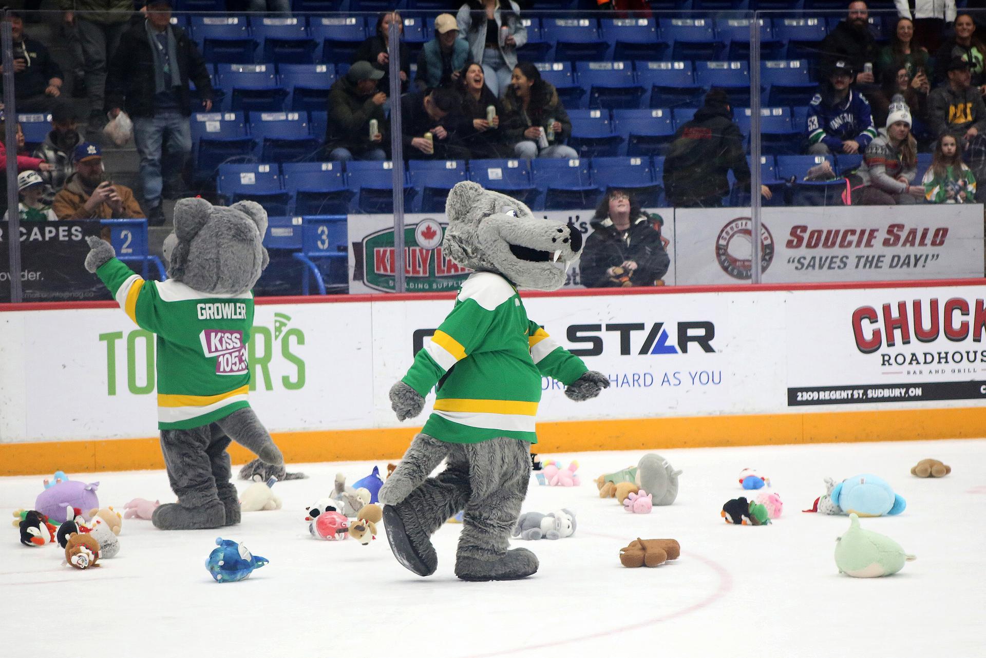Howler and Growler, the mascots for the Sudbury Wolves, patrol the ice during amid dozens of stuffed toys.