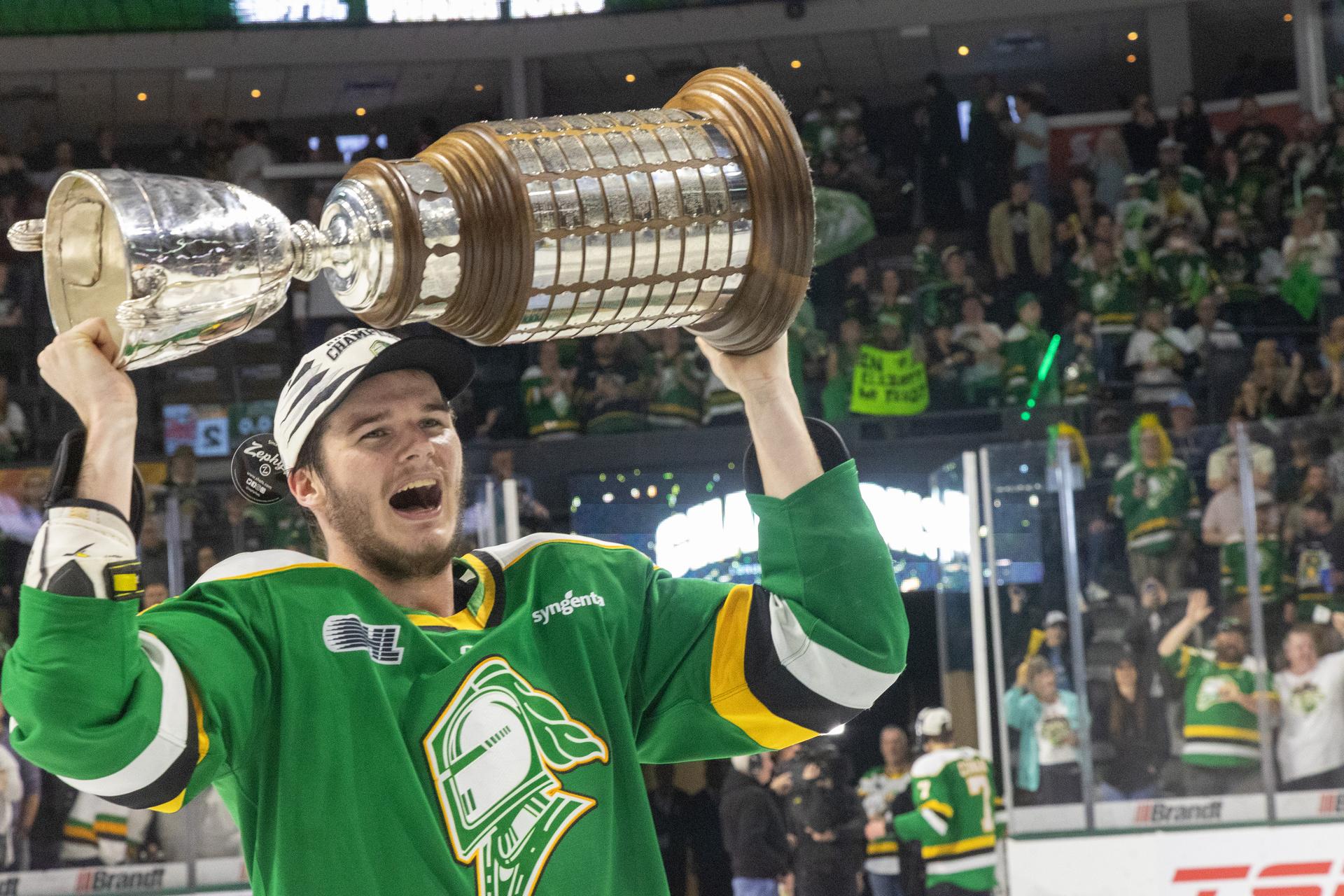 Sam Dickinson of the London Knights hoists the J. Ross Robertson Cup after defeating Oshawa 5-2 in game 5 of their OHL finals at Canada Life Place in London, Ont.