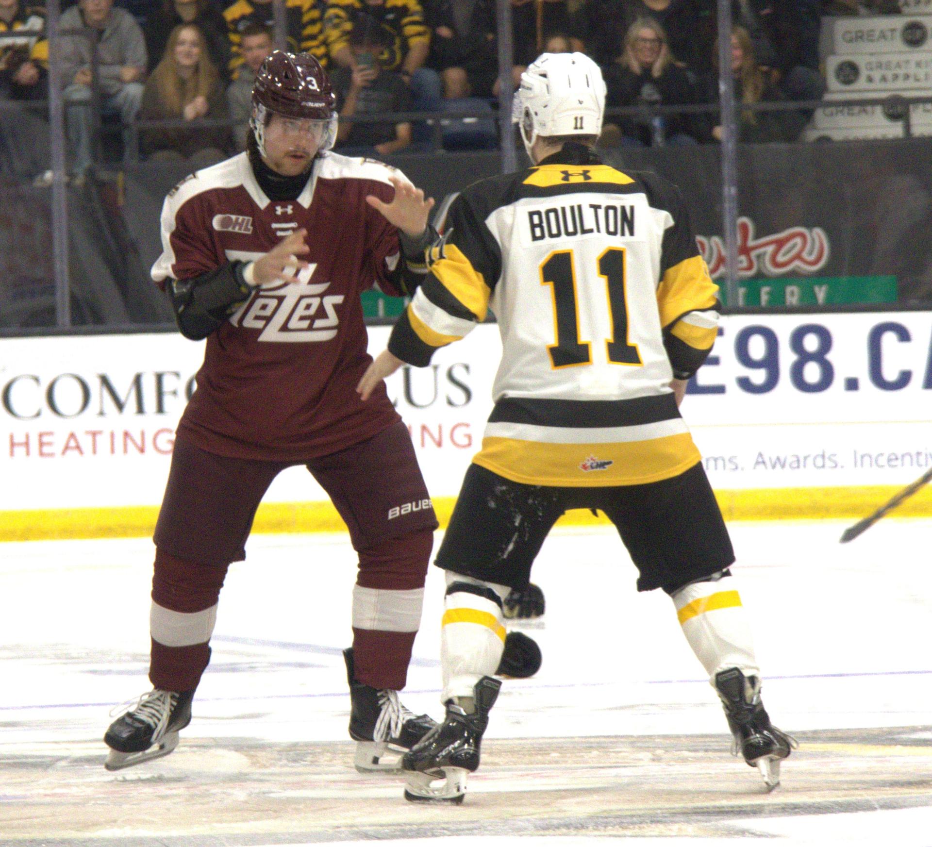 Ryder Boulton of Brantford Bulldogs and Thanasi Marentette of the Peterborough Petes square off during OHL action at the TD Civic Centre