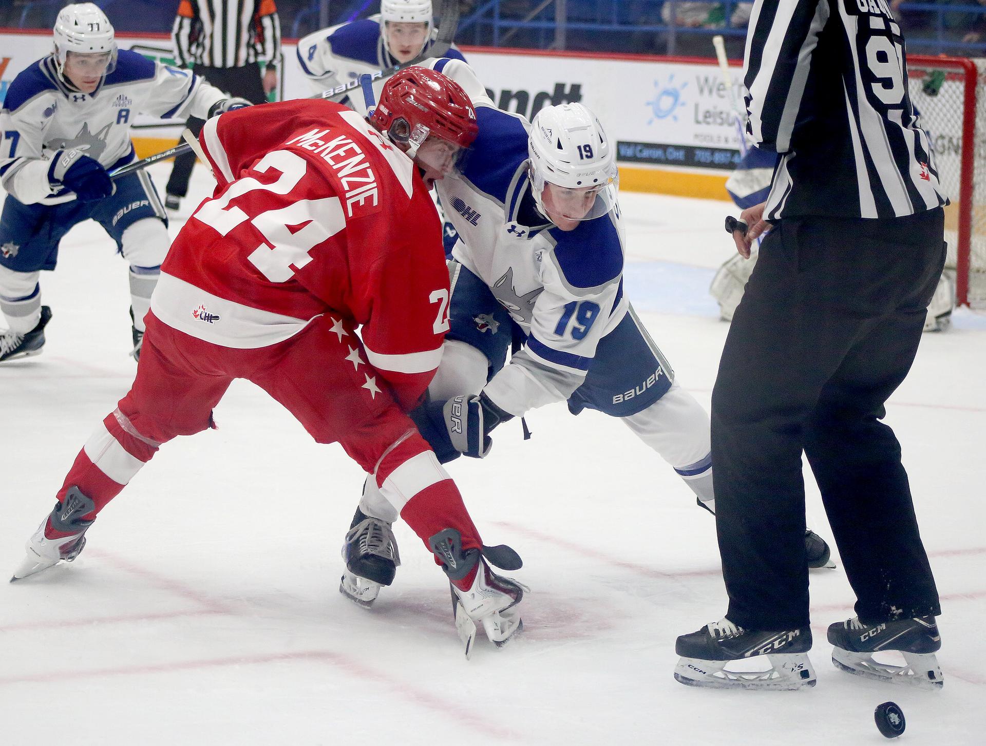 Blake Clayton of the Sudbury Wolves faces off against Quinn McKenzie of the Soo Greyhounds during OHL action at Sudbury Community Arena in Sudbury, Ont.